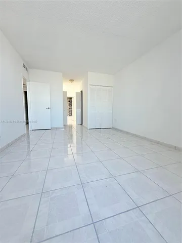 a view of a livingroom with an empty space and a window