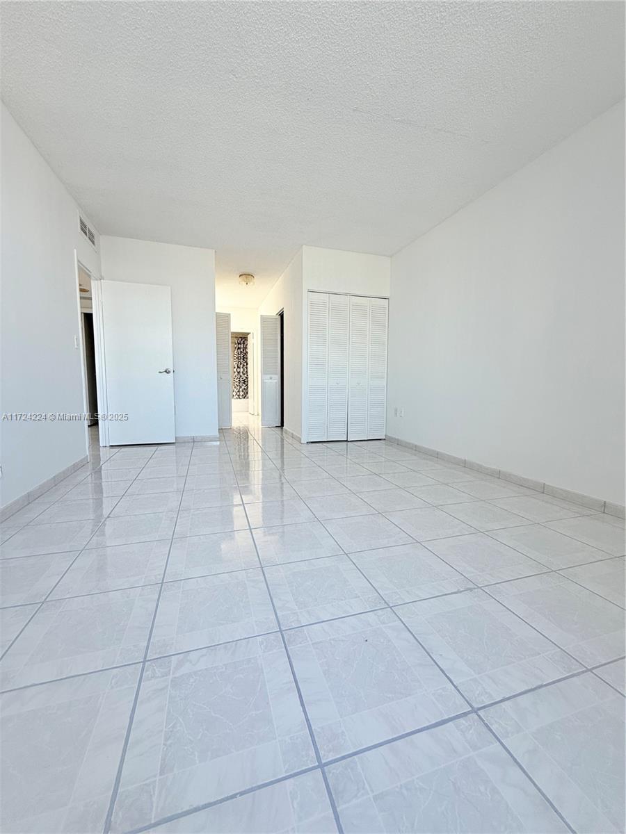 500 Bayview Drive, Unit 1031 Sunny Isles Beach, FL 33160 - Photo 24 of 40 a view of a livingroom with an empty space and a window