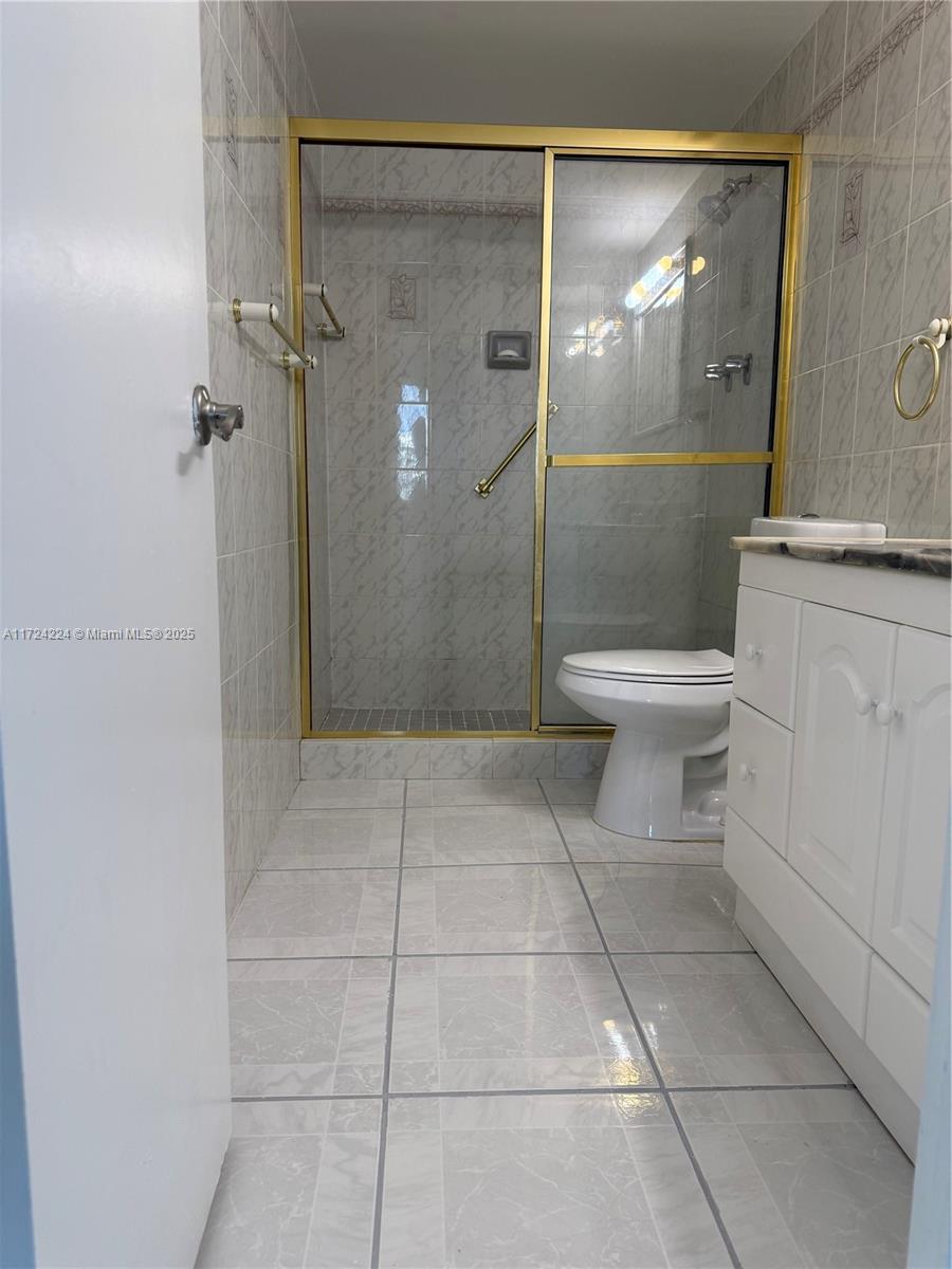 500 Bayview Drive, Unit 1031 Sunny Isles Beach, FL 33160 - Photo 31 of 40 a bathroom with a toilet and a shower