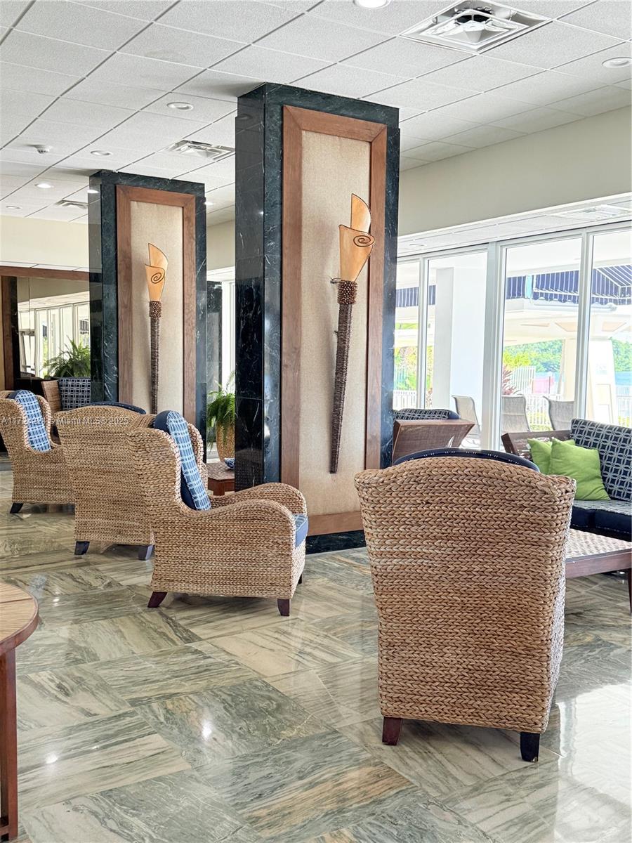 500 Bayview Drive, Unit 1031 Sunny Isles Beach, FL 33160 - Photo 6 of 40 a living room with furniture and large windows