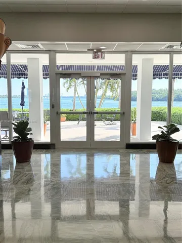 a living room with furniture and large windows