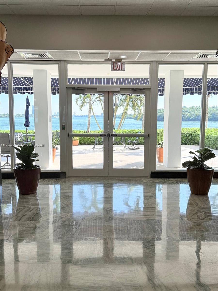 500 Bayview Drive, Unit 1031 Sunny Isles Beach, FL 33160 - Photo 8 of 40 a living room with furniture and large windows