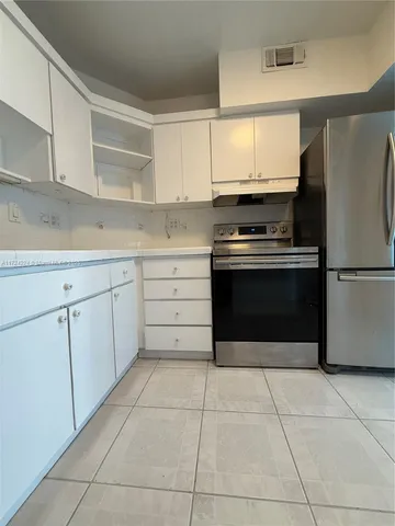 a kitchen with cabinets and steel stainless steel appliances