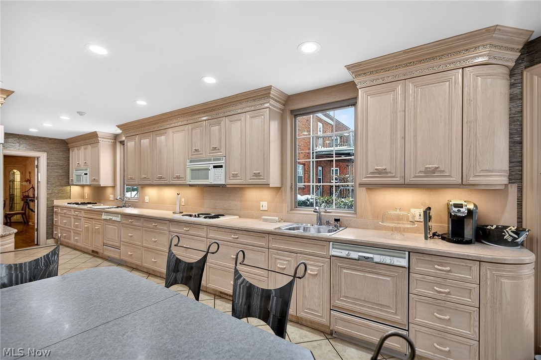 3498 Bainbridge Road Cleveland Heights, OH 44118 - Photo 24 of 50 Kitchen with paneled dishwasher, light tile patterned floors, white microwave, light brown cabinets, and recessed lighting