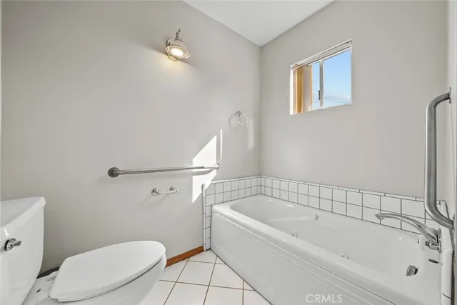 a white bath tub sitting next to a white toilet