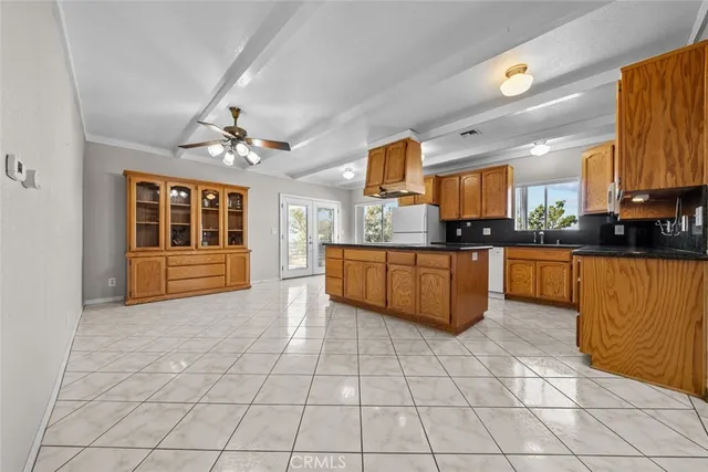 a kitchen with stainless steel appliances a sink a counter top space cabinets and a window