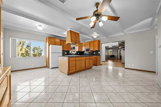 a kitchen with stainless steel appliances granite countertop a stove cabinets and living room view