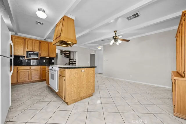 a kitchen with cabinets and steel appliances