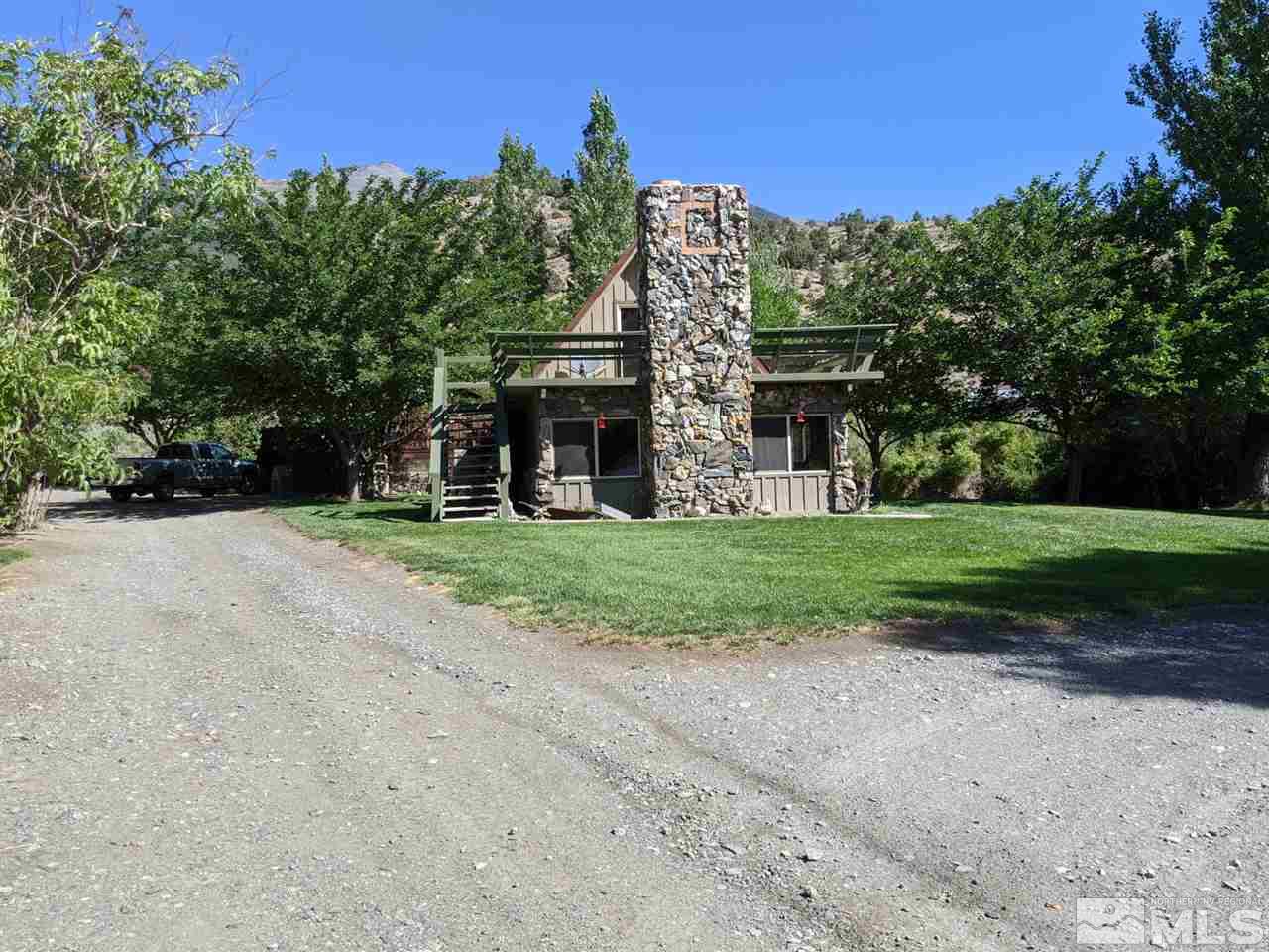6 Smokey Court Austin, NV 89310 - Photo 18 of 20 a view of a house with a yard and large trees