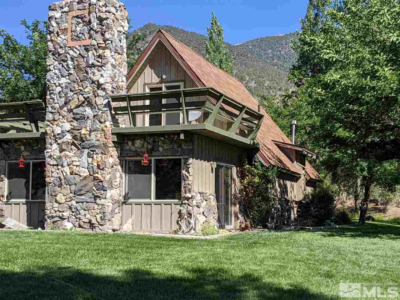 6 Smokey Court Austin, NV 89310 - Photo 2 of 20 a view of a house with a big yard and large trees