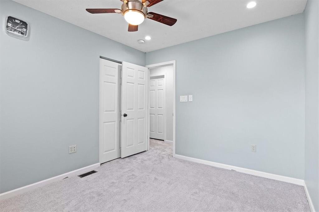 1025 Rural Ridge Drive Cheswick, PA 15024 - Photo 17 of 23 an empty room with a chandelier fan and a ceiling fan