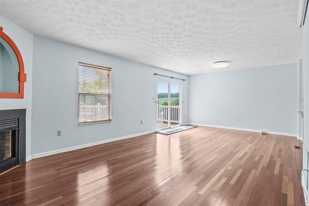 1025 Rural Ridge Drive Cheswick, PA 15024 - Photo 3 of 23 an empty room with wooden floor and windows