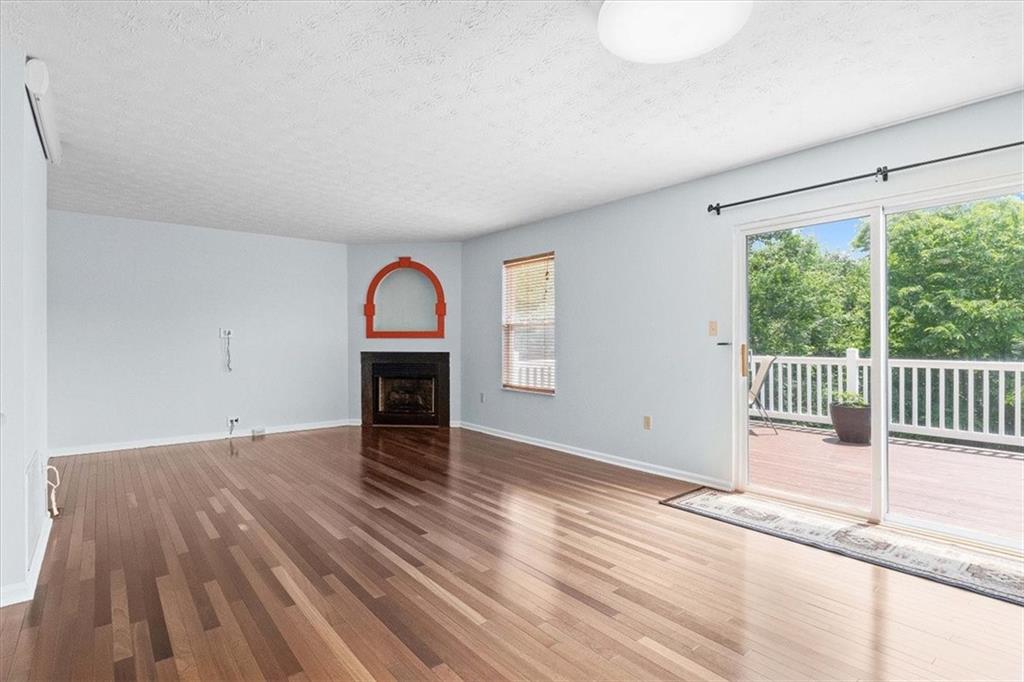 1025 Rural Ridge Drive Cheswick, PA 15024 - Photo 4 of 23 a view of empty room with wooden floor and fireplace