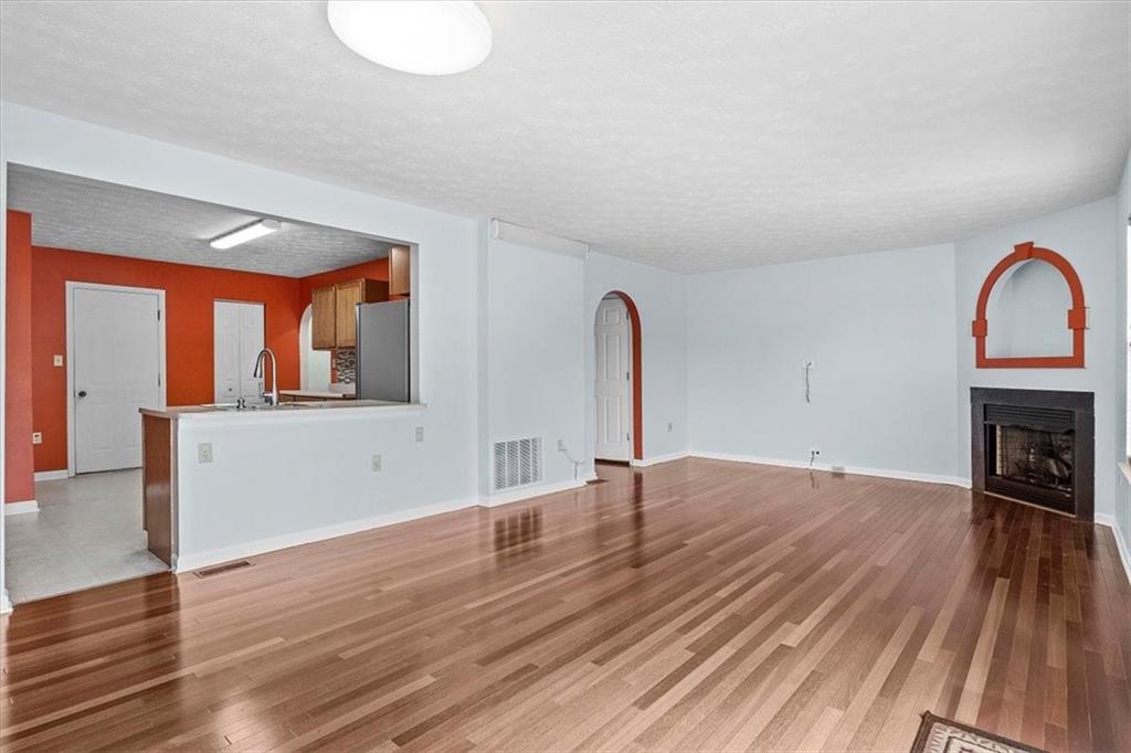 1025 Rural Ridge Drive Cheswick, PA 15024 - Photo 5 of 23 a view of empty room with wooden floor and fireplace