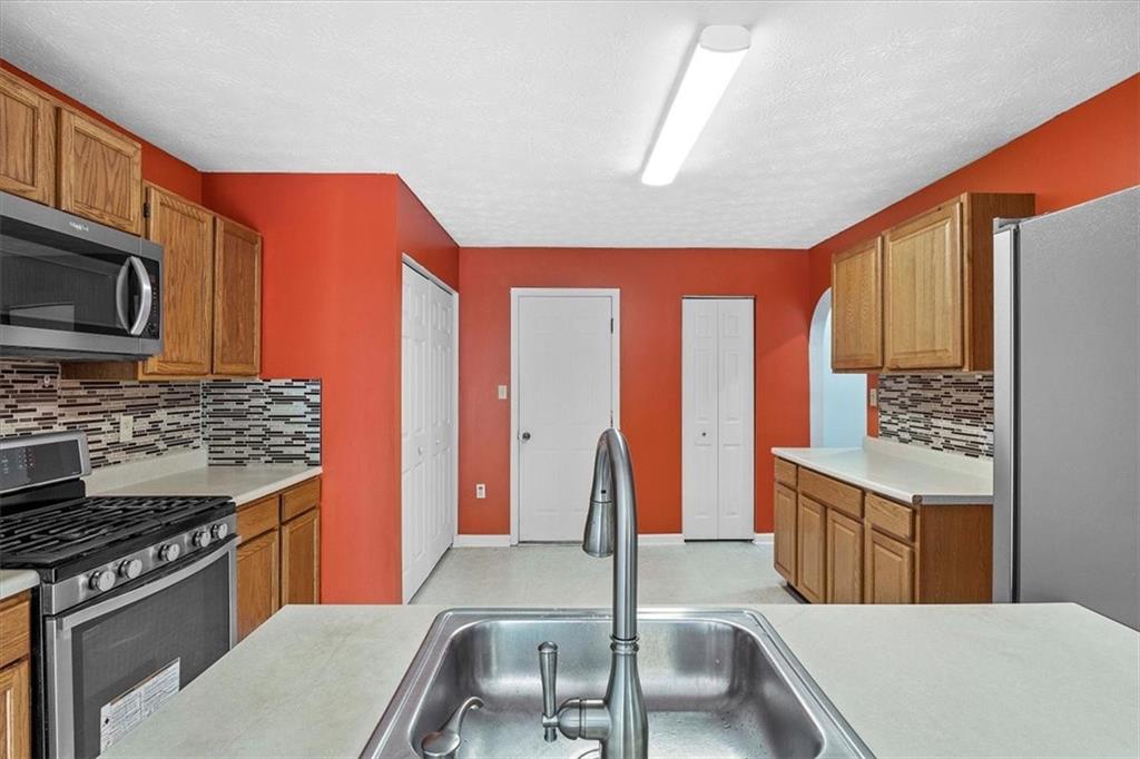 1025 Rural Ridge Drive Cheswick, PA 15024 - Photo 6 of 23 a kitchen with stainless steel appliances granite countertop a stove a sink and a microwave