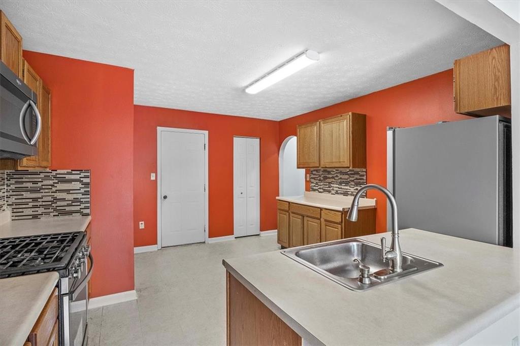 1025 Rural Ridge Drive Cheswick, PA 15024 - Photo 7 of 23 a kitchen with stainless steel appliances granite countertop a sink stove and refrigerator