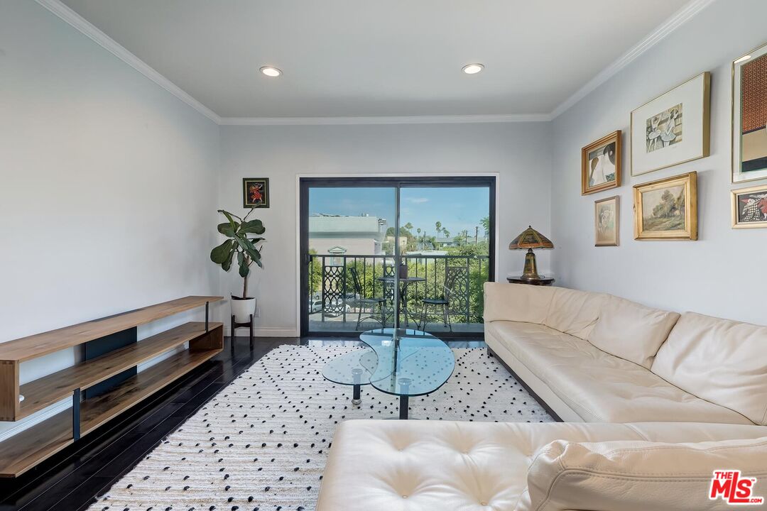a living room with furniture a window and a table