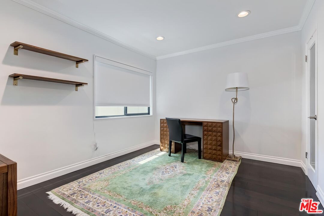 1045 North Kings Road, Unit 310 West Hollywood, CA 90069 - Photo 11 of 14 a view of room with window and wooden floor