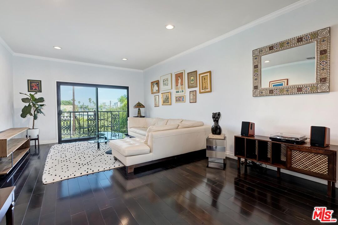 1045 North Kings Road, Unit 310 West Hollywood, CA 90069 - Photo 2 of 14 a living room with furniture and a large window