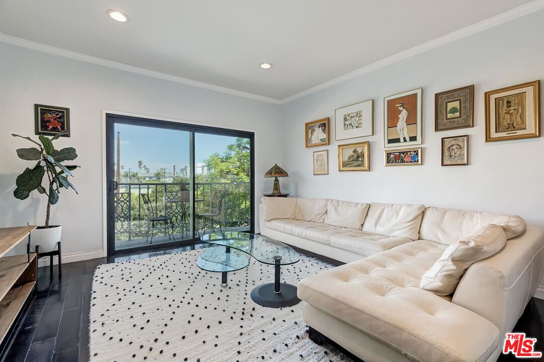 1045 North Kings Road, Unit 310 West Hollywood, CA 90069 - Photo 3 of 14 a living room with furniture and a floor to ceiling window