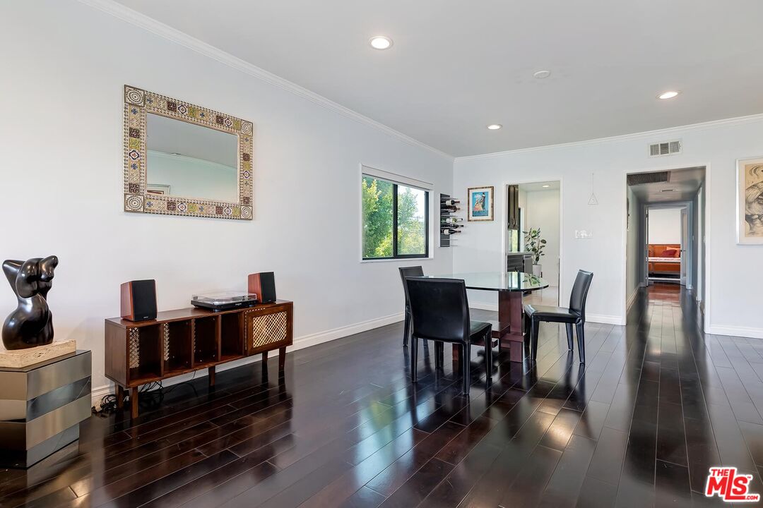 1045 North Kings Road, Unit 310 West Hollywood, CA 90069 - Photo 6 of 14 a view of a dining room with furniture window and wooden floor