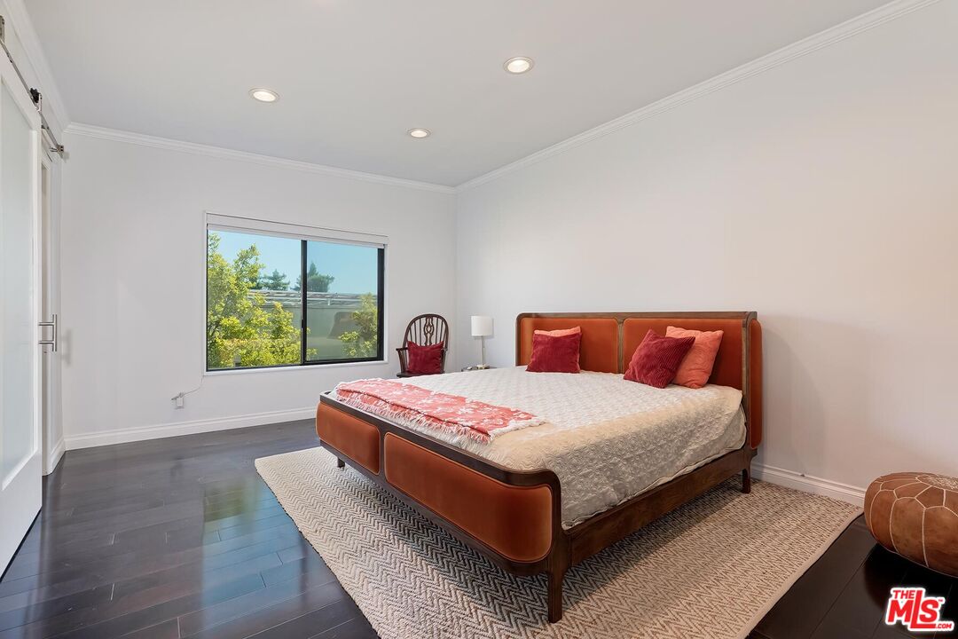 1045 North Kings Road, Unit 310 West Hollywood, CA 90069 - Photo 9 of 14 a bedroom with a bed and a window