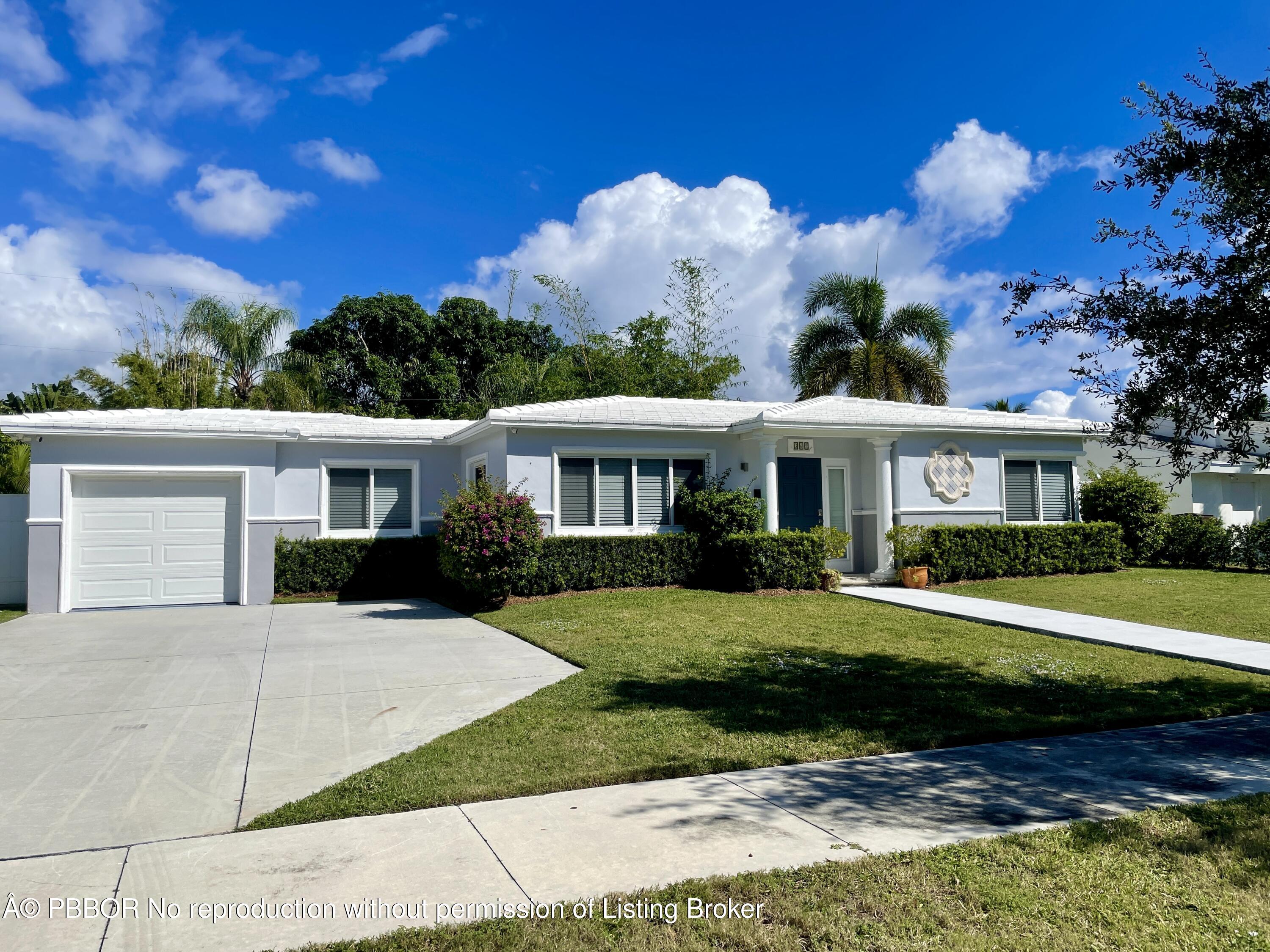 369 Valley Forge Road West Palm Beach, FL 33405 - Photo 1 of 19 a front view of a house with a garden and trees