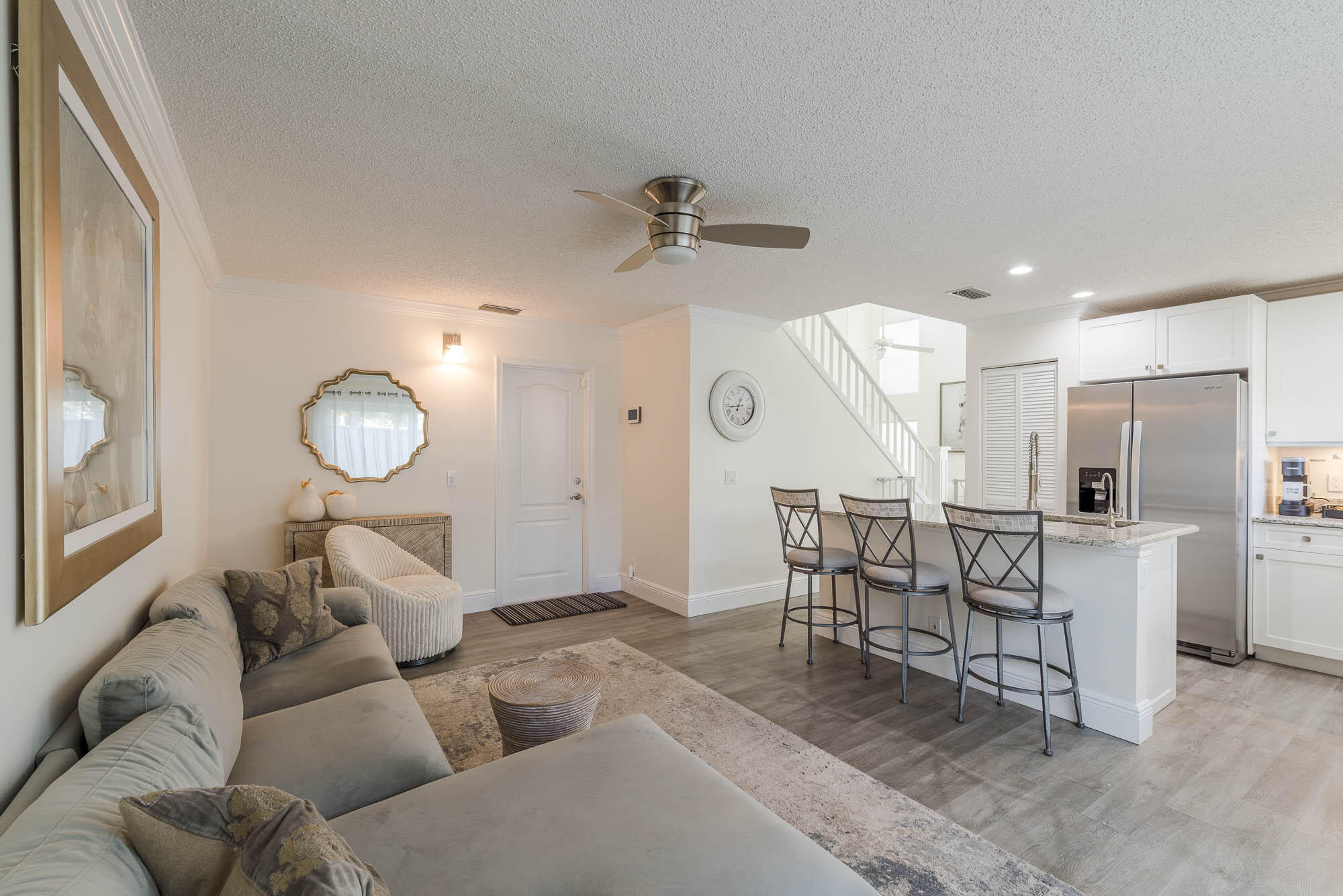 25 Commodore Place Palm Beach Gardens, FL 33418 - Photo 14 of 68 a living room with furniture a window and kitchen view