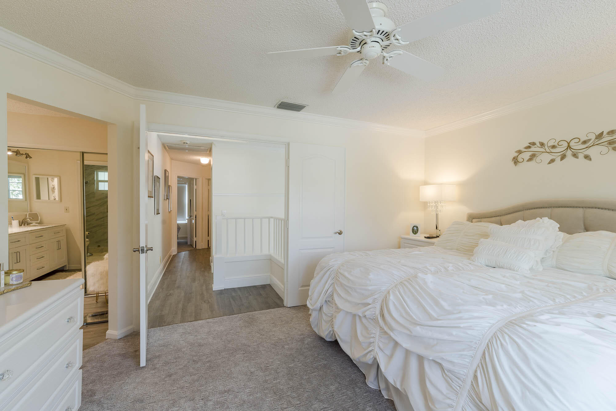 25 Commodore Place Palm Beach Gardens, FL 33418 - Photo 17 of 68 a bedroom with a bed and a chandelier