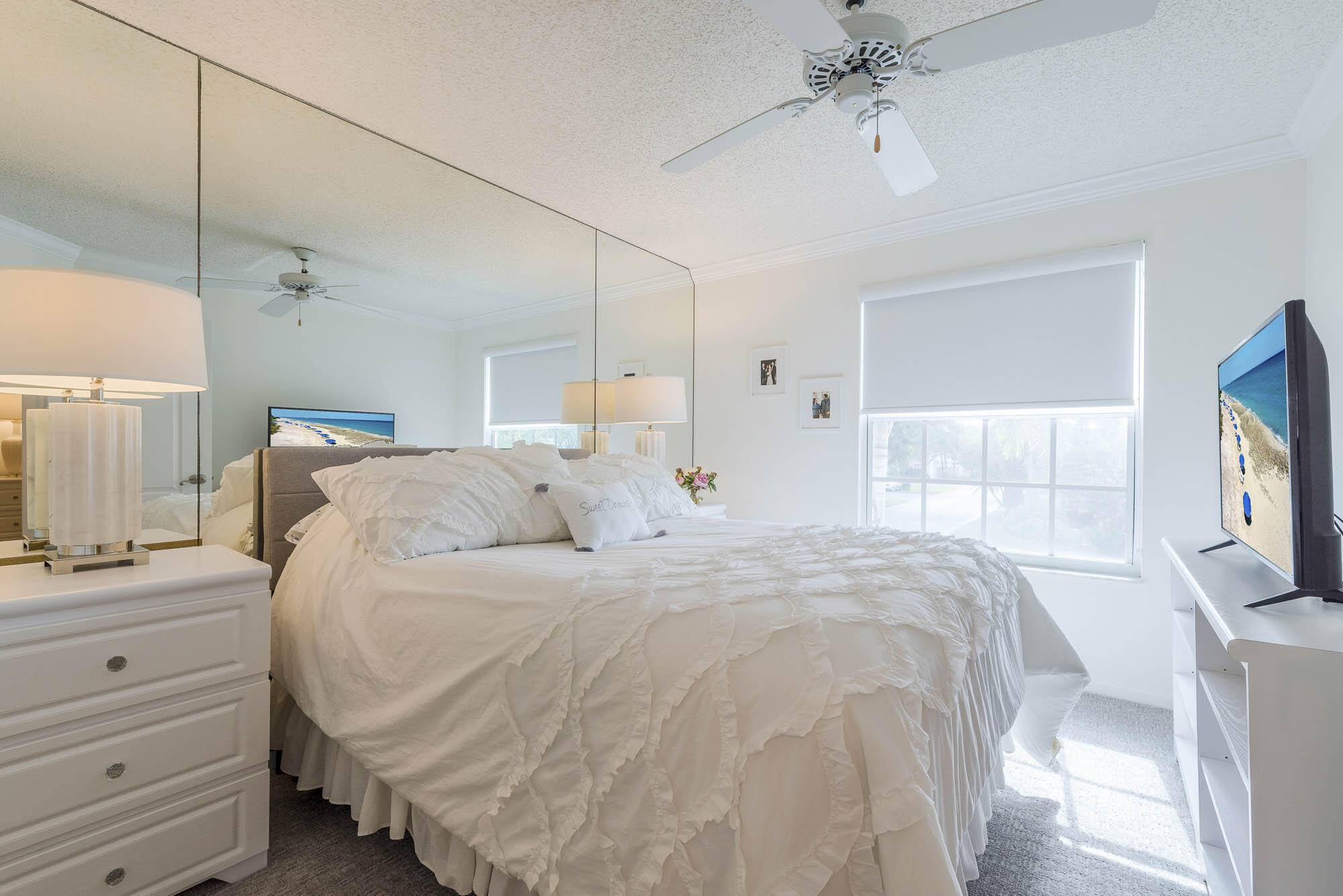 25 Commodore Place Palm Beach Gardens, FL 33418 - Photo 21 of 68 a spacious bedroom with a bed and a flat screen tv