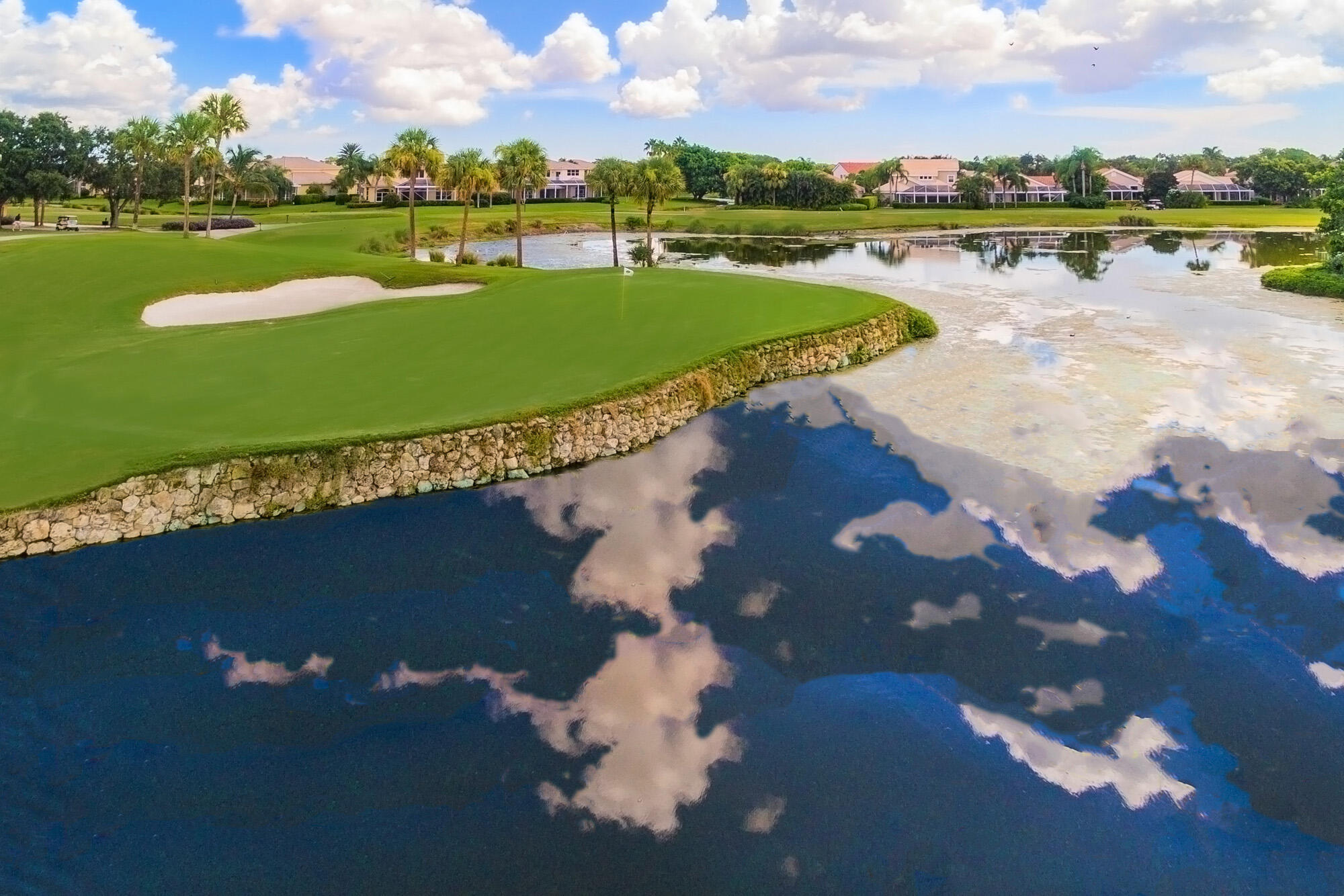 25 Commodore Place Palm Beach Gardens, FL 33418 - Photo 40 of 68 a view of a lake with houses in the back