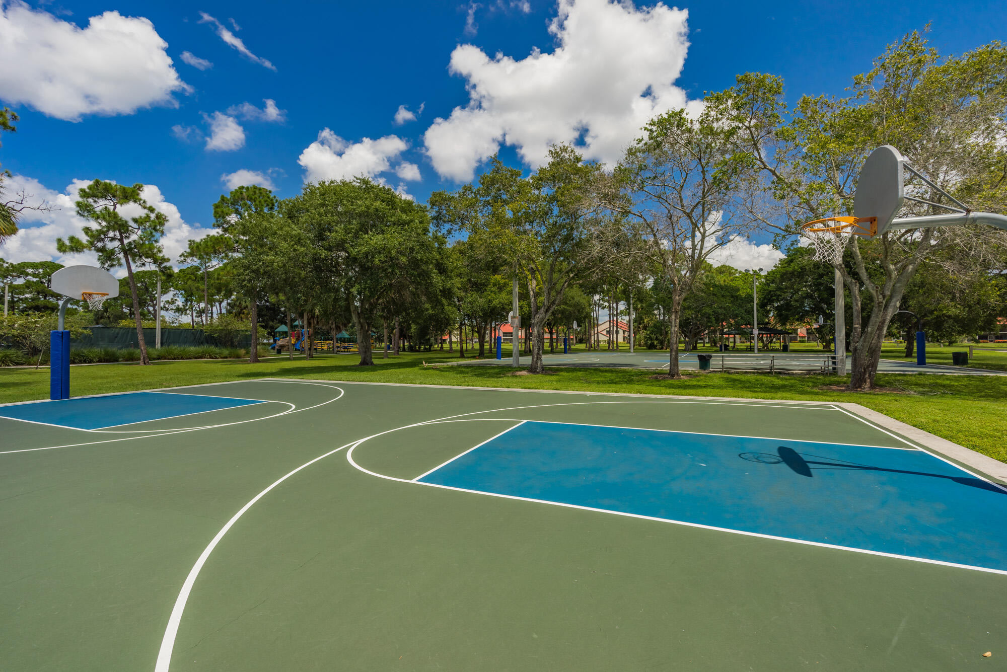 25 Commodore Place Palm Beach Gardens, FL 33418 - Photo 48 of 68 a view of a tennis ground with large trees