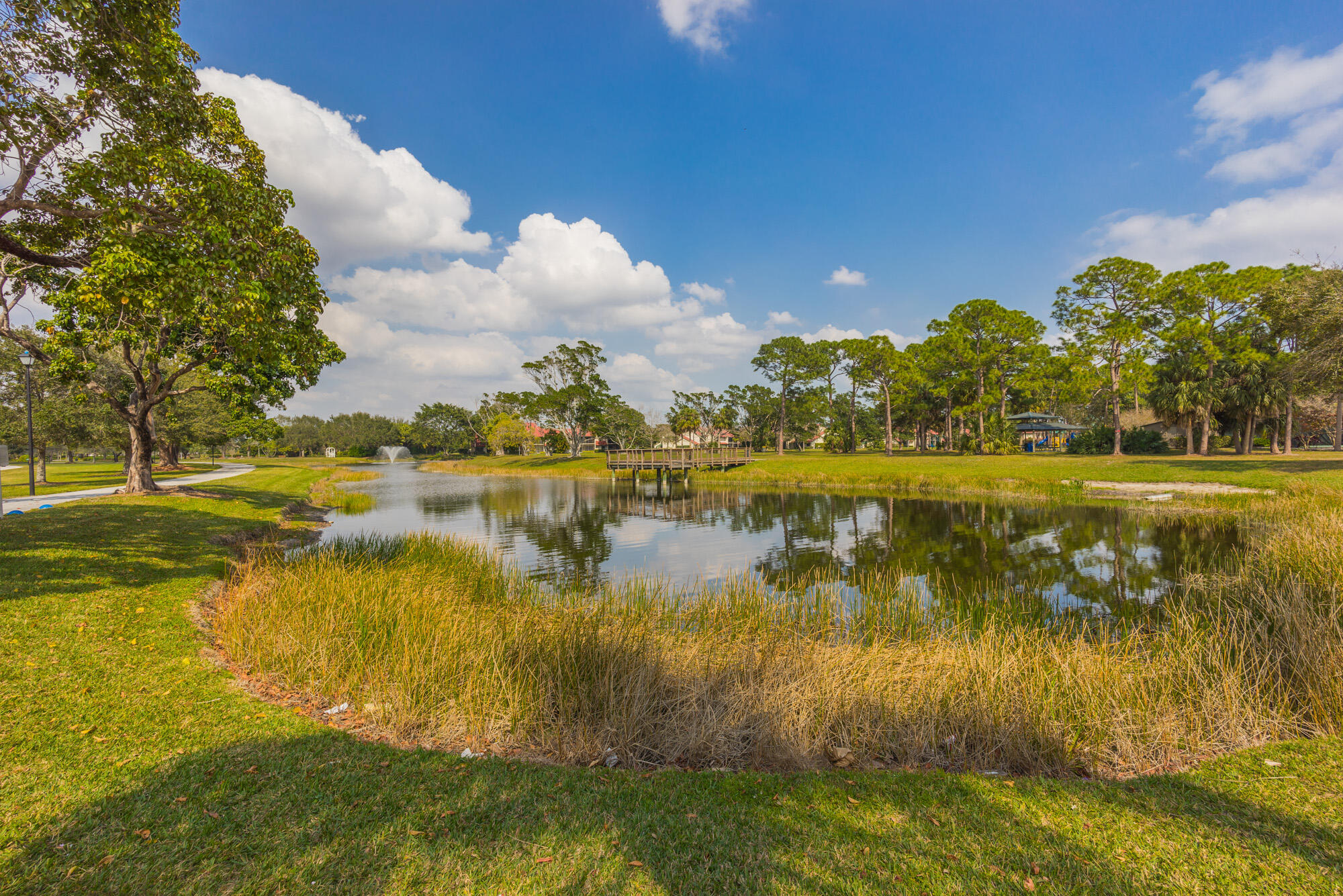 25 Commodore Place Palm Beach Gardens, FL 33418 - Photo 57 of 68 a view of a lake with houses in the back