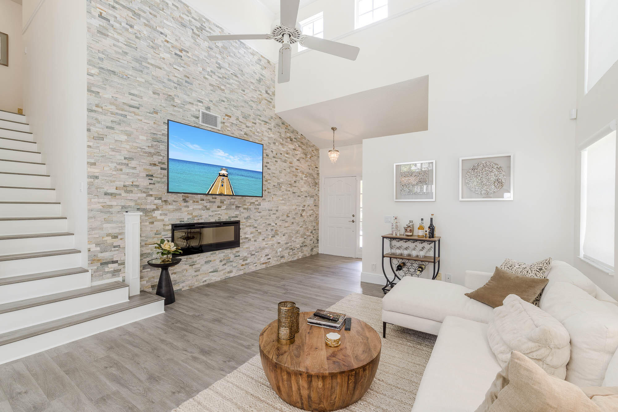 25 Commodore Place Palm Beach Gardens, FL 33418 - Photo 6 of 68 a living room with furniture a fireplace and a flat screen tv