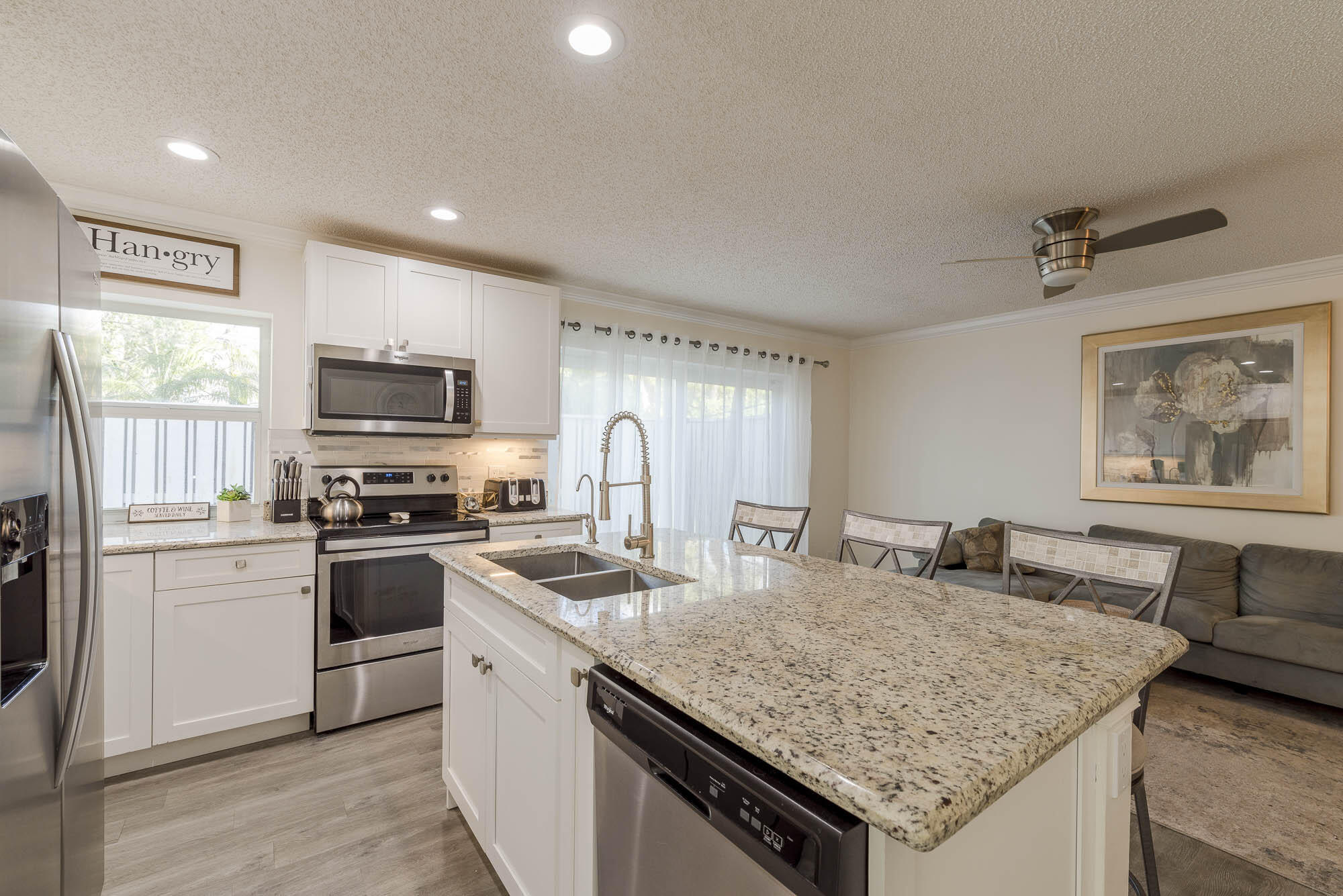 25 Commodore Place Palm Beach Gardens, FL 33418 - Photo 10 of 68 a kitchen with stainless steel appliances granite countertop a sink dishwasher stove and refrigerator