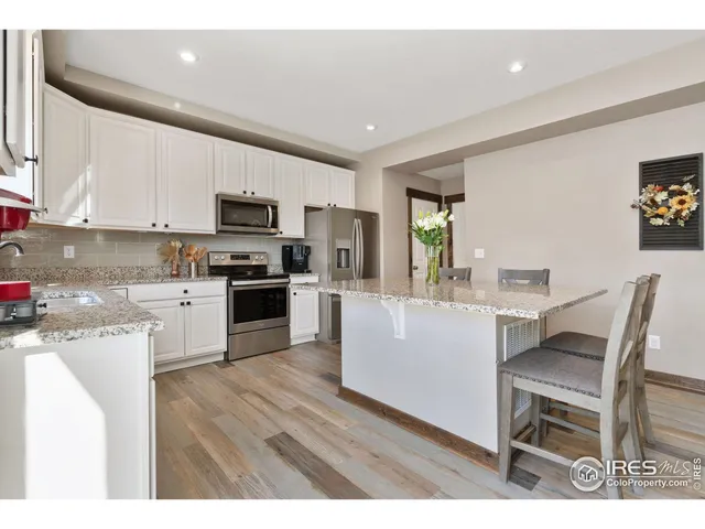 a kitchen with a sink cabinets and wooden floor