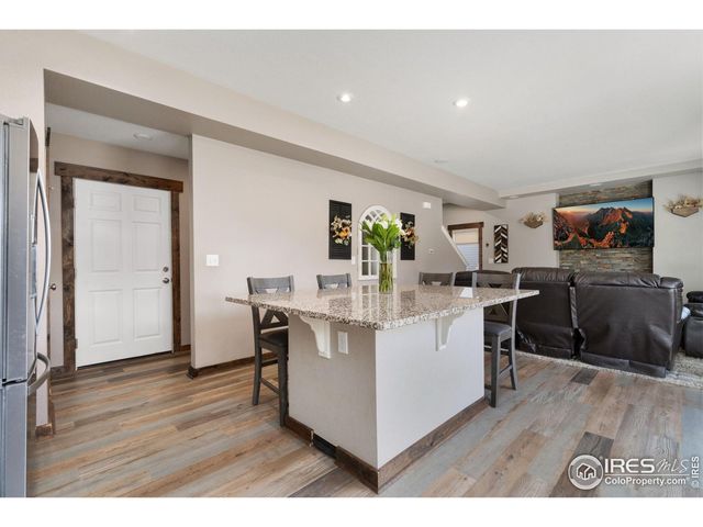 a kitchen with a sink cabinets and wooden floor