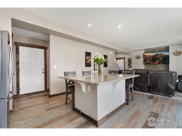a kitchen with a sink cabinets and wooden floor