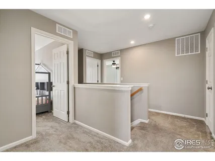 a room with a sink and a large mirror