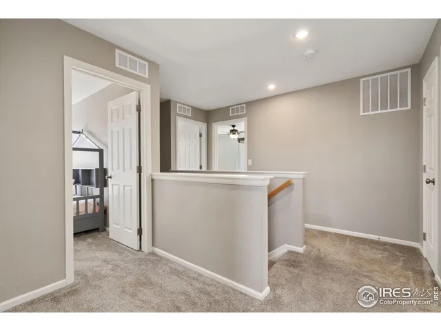 a room with a sink and a large mirror