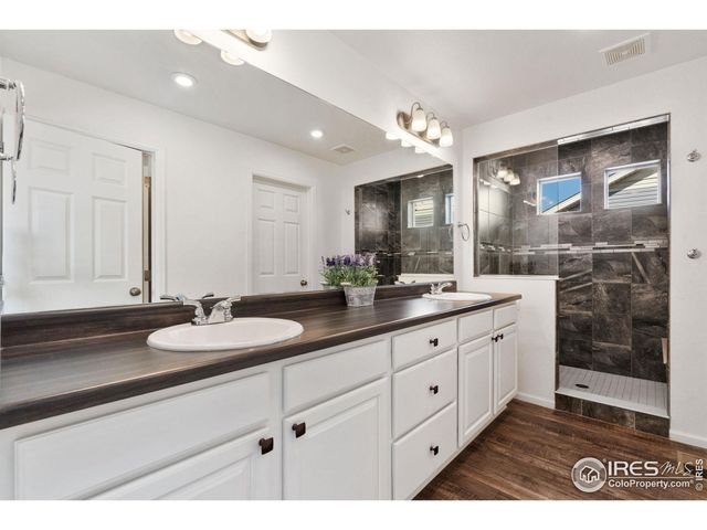 a bathroom with a sink double vanity and a mirror