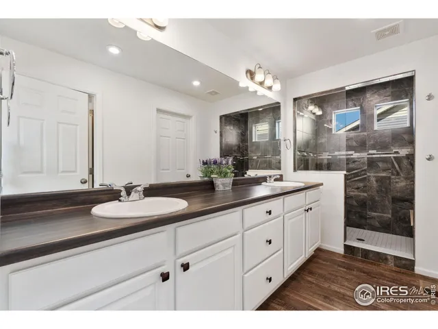 a bathroom with a sink double vanity and a mirror
