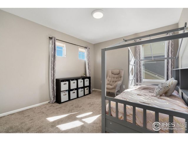 a bedroom with furniture and a large window