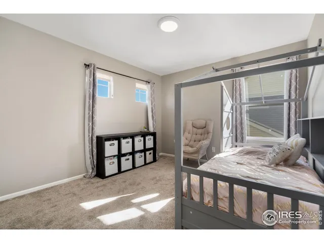 a bedroom with furniture and a large window