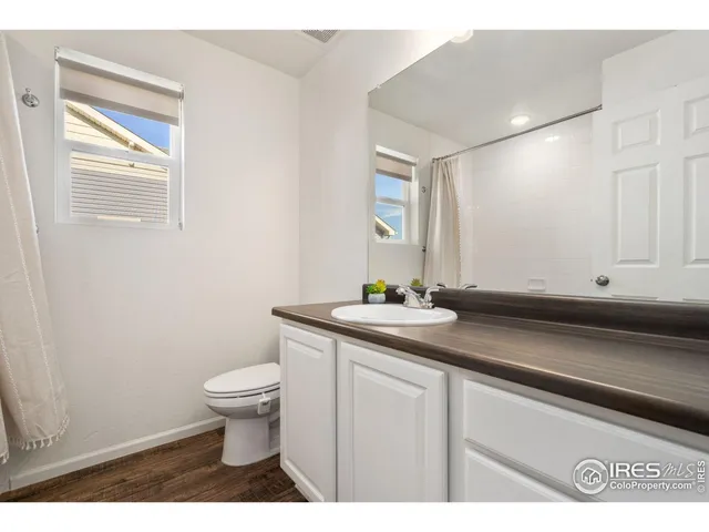 a view of a livingroom and a kitchen with car parked