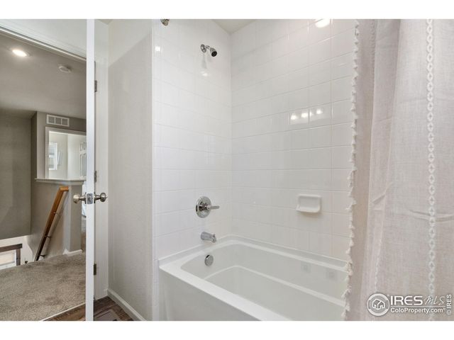 a view of a deck with couches floor to ceiling window and potted plants