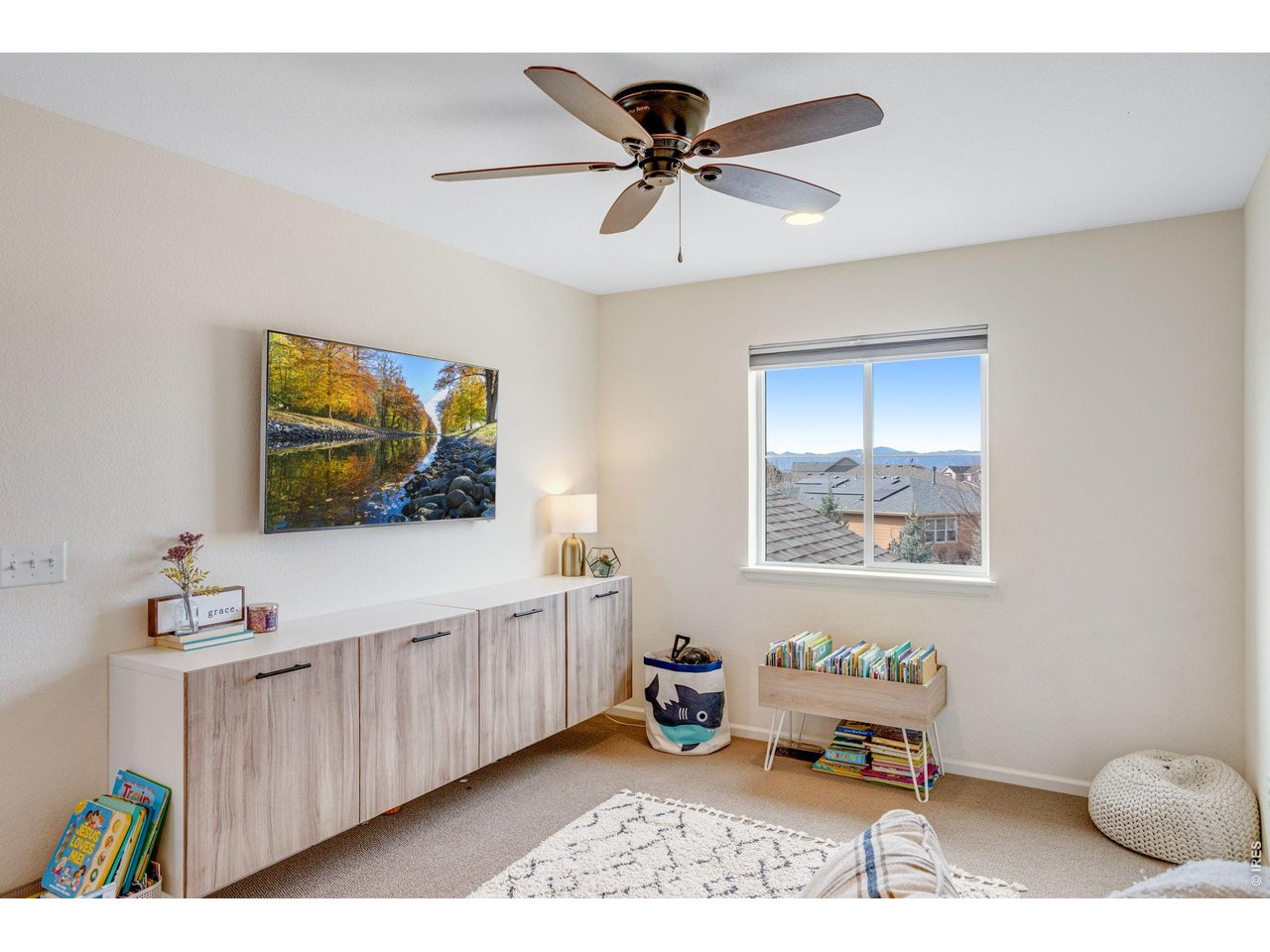 12715 Eagle River Road Firestone, CO 80504 - Photo 14 of 28 Light-filled upper-level loft space with custom built in cabinets and has neighborhood and mountain views.
