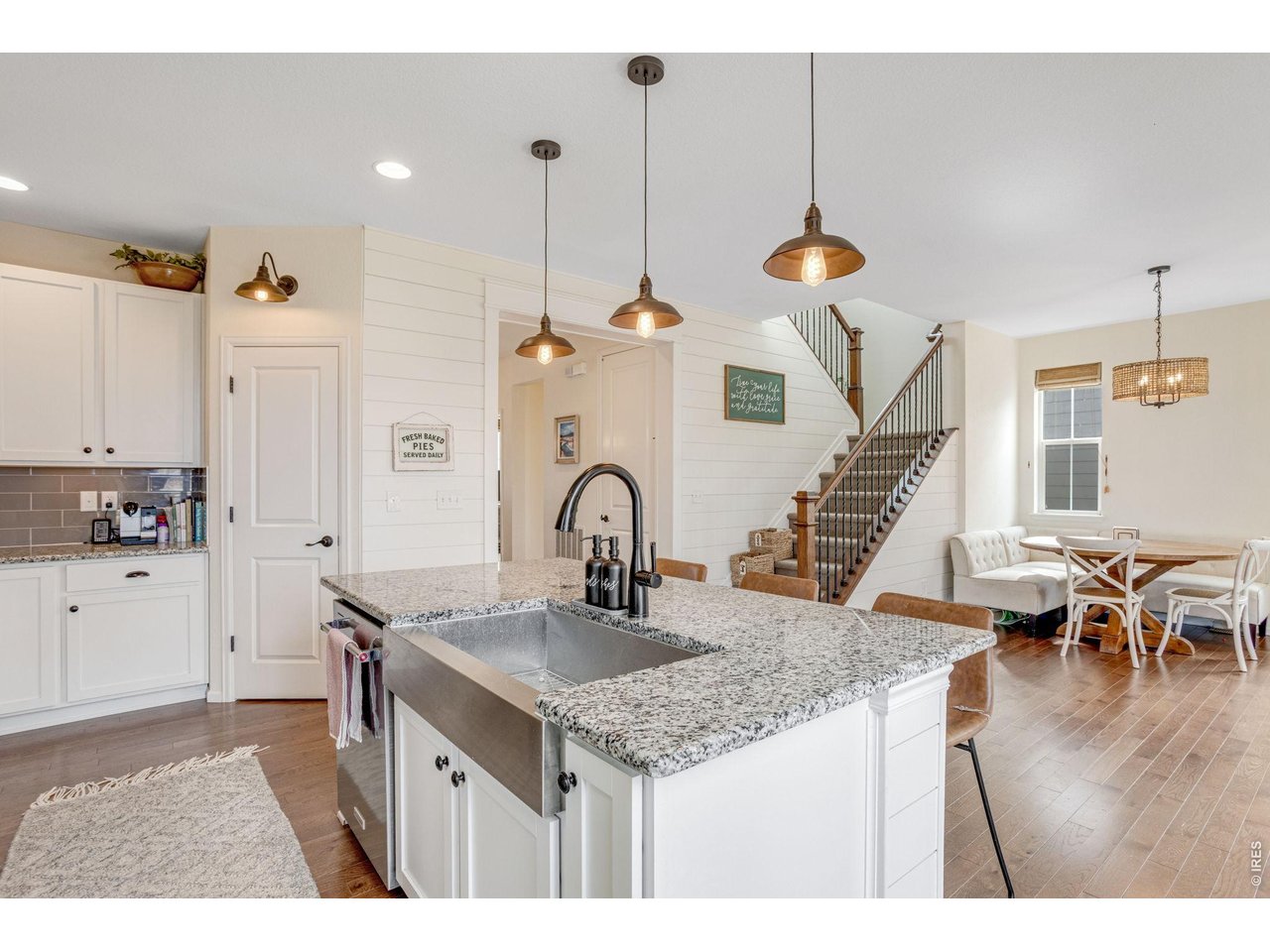 12715 Eagle River Road Firestone, CO 80504 - Photo 10 of 28 Modern kitchen details with farmhouse sink, pendant lighting, ample prep space, and a large pantry.