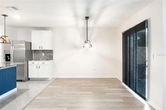 a view of a kitchen with refrigerator and microwave