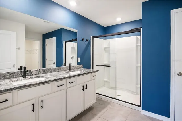 a bathroom with a granite countertop sink mirror and double